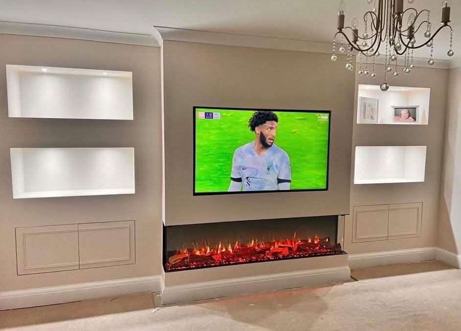 Fireplace media wall with lit alcoves and cupboards